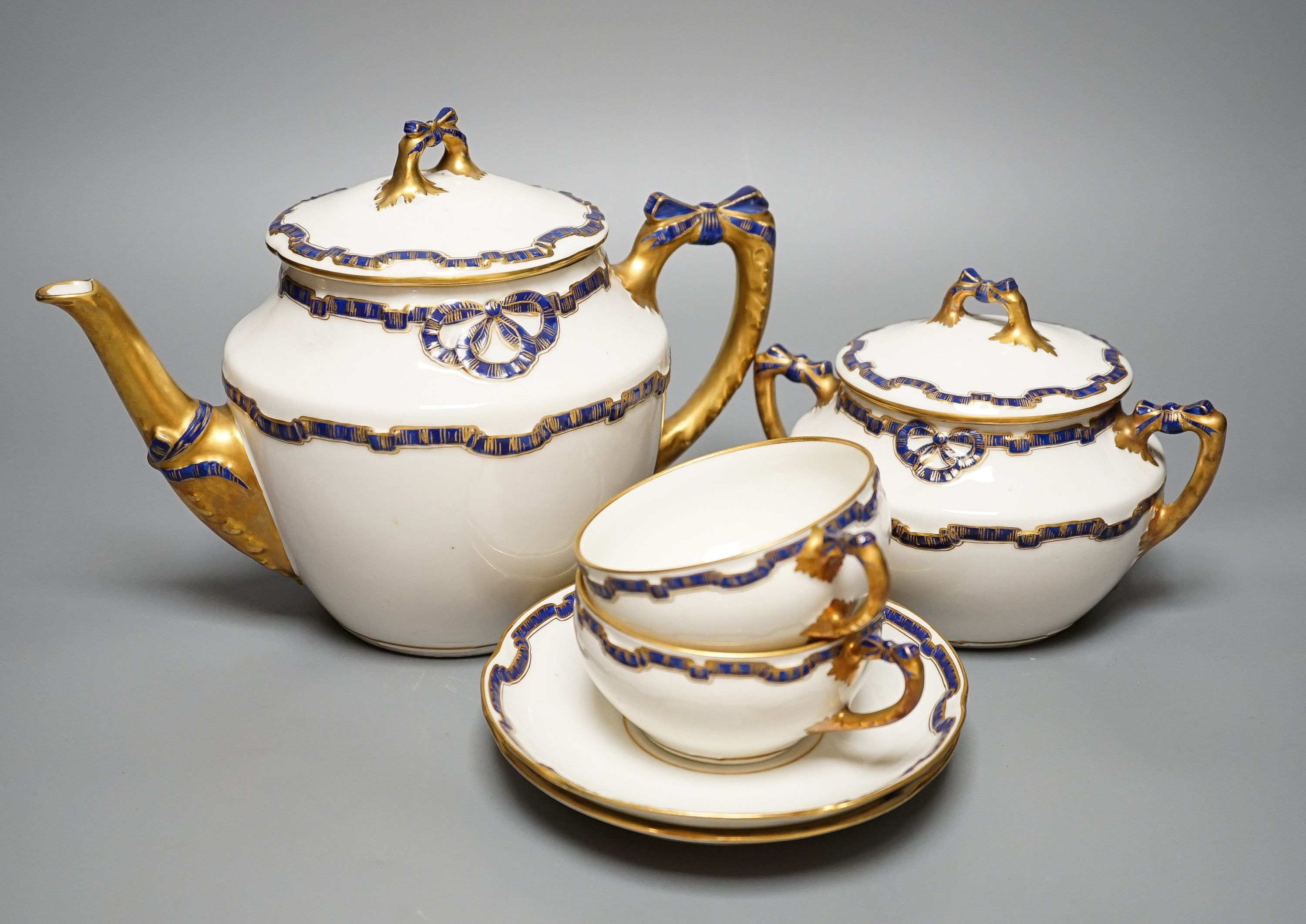 An early 20th century Richard Ginori gilt and blue ribbon decorated tea set